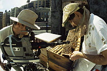 Cameraman Rod Clarke filming bee-keeper on top of apartment building, Manhattan, New York, for BBC Natural World programme: Metropolis. 1997