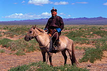 Man on horseback, in traditional clothing, Gobi Desert, Mongolia.