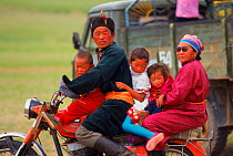 Mongolian family on motorbike, Gobi Desert, Mongolia.
