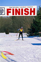Person crossing finishing line, cross country ski race, Wisconsin, USA