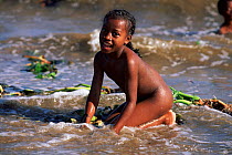 Portrait of Betsimisaraka girl playing in surf, near Maroantsetra, NE Madagascar
