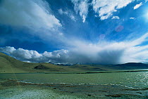 Rain clouds approaching, start of monsoon with dramatic sky over lake, Ladakh, North East India