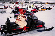 Ellen Buljo in traditional costume on a skidoo - the new and the old, Saami Easter,