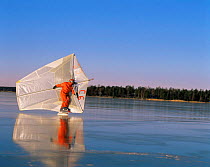 Surfing on frozen ice surface of lake, Sweden