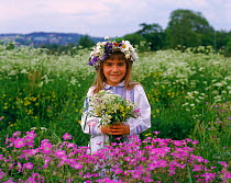 Young girl with garlands of meadow flowers Sweden