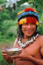 Indian in traditional Zaparo dress with drink. Llanchamacocha, Amazonian Ecuador