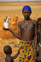 Fulani woman with caught fish in tin, Mali, West Africa