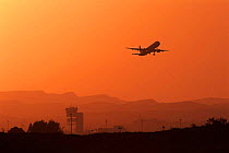 Aeroplane taking off into sunset, Alicante, Spain