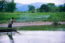 Fisherman throwing traditional cast net, Maroantsetra, Madagascar