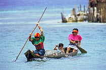Kuna Indian family in boat crossing water, San Blas Islands, Panama