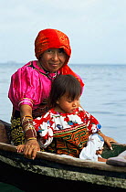 Kuna indian grandmother in boat with child, San Blas islands, Panama