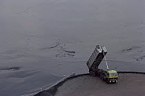 Lorry dumping coal slurry, Ruhr valley, Germany