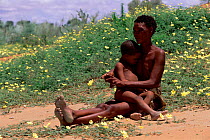 San woman holding child Kalahari desert, South Africa