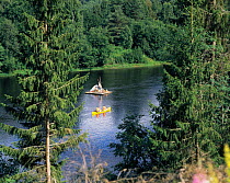 Leisure canoe and raft making their way down river, Varmland, Sweden