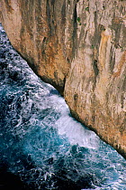 Waves breaking against rock cliff off Cape Formentor, Mallorca, Spain