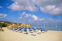 Beach scene with loungers and parasols, Cala Sahona, Formantera Is, Balearic Islands, Mediterranean