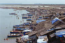 Boats and slum huts on the shores of River Ganges, Garnmuktesar, Uttar Pradesh, India