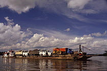 Lorries transported across Napo river for road construction for oil exploration, Ecuador Amazonia