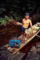 Ot Danum tribesman fishing with electric stun machine, West Kalimantan, Borneo. Indonesia