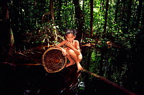 Young Sakai boy fishing in swamp forest, Riau, Sumatra, Indonesia
