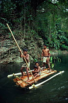 Batak Tribesmen and children on raft on river Palawan, Philippines