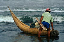 Launching traditional fishing boat, Huancaco, Peru
