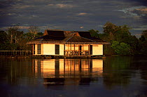Dramatic evening light on Mamiraua tourist lodge in flooded forest, Amazonia, Brazil
