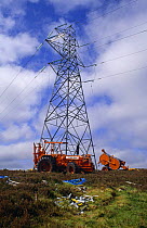 Erecting new cables on electricity pylon Inverness, Scotland, UK