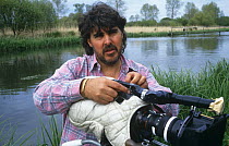 Camerman Mike Fox filming on location at the River Test in Hampshire for BBC programme "Tales from the Riverbank", UK, May 1996