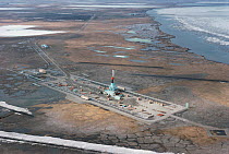 Aerial view of oil drilling rig on coastal wetlands, Prudhoe Bay, Alaska, USA 1988