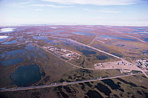 Aerial view of oil drilling rig on coastal wetlands, Prudhoe Bay, Alaska, USA  1988