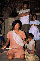 Quechua Indian woman making palm fibre string, Ecuadorian Amazon 2002