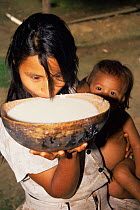 Quichua / Quechua Indian woman drinking chicha, Napo River, Ecuadorian Amazon, South America