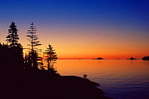 Coastline silhouetted at sunset, Isle Royale NP, Lake Superior, Michigan, USA
