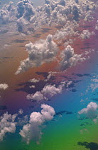 Looking down onf Clouds over Atlantic Ocean with rainbow colours