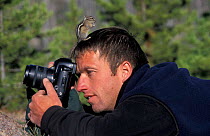 Least chipmunk {Eutamias minimus} on head of photographer Mark Hamblin in  Yellowstone NP, WY, USA Model released.
