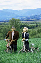 Victorian scarecrows - mock man and woman with bicycles, Strathspey, Scotland, UK