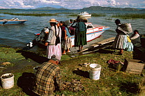 Aymara indians sorting fish catch, Lake Titicaca, Bolivia