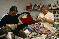 Inuit women make clothes from seal and caribou skins, Nunavut, Baffin Island, Canadian Arctic
