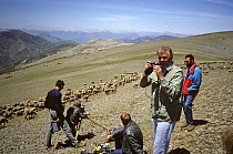 David Attenborough taking photographs while the film crew set up their equipment. On location in Soria, Spain, filming for the BBC programme "The First Eden", 1986