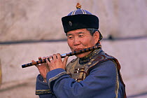 Mongolian performer in traditional costume, playing pipe, Gobi desert, Mongolia. 2001