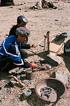 Kazakh nomads making metal horse shoes nr Tsengle Khairkhan Mt, Western Mongolia. 2001