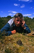 Photographer and herpetologist Tony Phelps face to face with an Adder {Vipera berus} in Dorset, UK