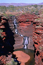 Joffre Falls with iron bands in 2,500 million-year-old rocks, Karijini NP, Western Australia.