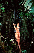 Huaorani indian hunting with blow pipe and curare in rainforest, Yasuni NP, Ecuador