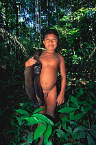 Huaorani Indian boy with Woolly monkey hunted for food Yasuni NP, Ecuador