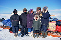 Cameraman Doug Allan with Inuit family +and sledges on filming trip, Nunavut, Canada