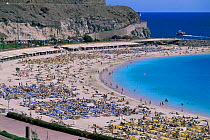 Amadores beach covered with holiday makers, Gran Canaria, Canary Isles, Spain