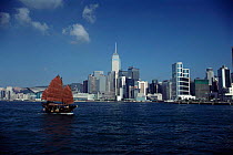 Hong Kong harbour and ocean front with traditional Chinese junk / sailing boat, Kowloon, Hong Kong, China.