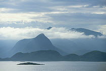 View across sea to Vestvagoy Island in clouds, Lofot Islands, Norway, Europe